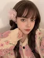 Elegant pink fabric orchid flower hair clip worn on side by a model for a soft Korean look - Pink Fabric Flower (21)