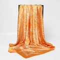 Detail of orange paisley satin square scarf elegantly draped on a black display stand - Orange White Classic Paisley (FT264-5)