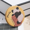 Portable folding makeup mirror with cute panda design on a wooden desk background - Panda Hiding Face
