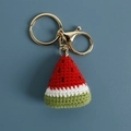 Handmade crochet watermelon keychain with vibrant knitted yarn and golden metal clasp - Red