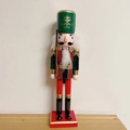 Classic wooden nutcracker soldier figure with green hat and rifle on a red square base - Green Soldier with Rifle
