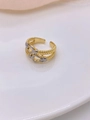 Close-up of gold and silver horseshoe buckle ring with cubic zirconia on white plate - Gold Silver Two-tone Horseshoe Braided Design