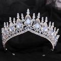 Macro detail of Baroque silver bridal crown featuring teardrop blue crystals on black silk - Silver White Rhinestone + Blue Opal