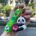 Detail of cute panda keychain with donut and green silicone strap with PANDA lettering - Panda Gen 4 - Style 03