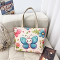Ethnic floral canvas tote bag featuring vibrant butterfly prints and sturdy ribbon handles - Style 3