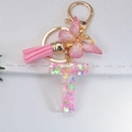 Pink resin letter T keychain with glitter butterfly, metal charm and leather tassel - Letter T