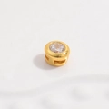 Macro shot of a gold-plated round cubic zirconia charm with a polished finish - Gold Round Beaded