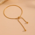 Detail of adjustable gold snake chain bracelet with sliding clasp and gold beads - Cross Drawstring Bracelet (C605)