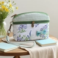 Floral print coin purse in green and white cotton with a decorative bow on wooden table - Green Bouquet Coin Purse