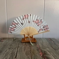 Chinese style folding fan with bird and flower patterns on a bamboo stand - Peach Branch and Magpie
