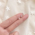 Minimalist silver geometric triangle stud earrings held by hand to show size and scale - Hollow Triangle / Silver