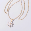 Macro shot of gold flower pendant with clear zircon crystals on minimalist chain - Crystal Flower Necklace (SE1119)