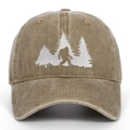 Close-up of Bigfoot and pine forest white embroidery on washed brown cotton baseball cap - Khaki