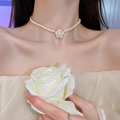 Detailed view of cream pearl necklace featuring an elegant camellia flower pendant - White Camellia