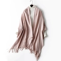 Pink wool blend winter scarf with fringe tassels shown on a hanger with a sweater - Light Pink