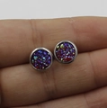 Detailed shot of 8mm purple sparkle stainless steel stud earrings held in hand - Purple/Iridescent (3)