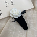 Elegant camellia hair clip with creamy white satin petals and a black ribbon bow - Milky White
