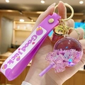 Purple lollipop liquid sand keychain with flower charm and Good Luck silicone strap - Bead Lollipop - Purple