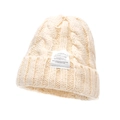 Chunky cable knit beanie in cream white with a decorative woven label for women - Adjustable / Beige