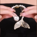 Detailed close-up of golden fishtail hair claw clip with pearls and sparkling rhinestones - F0384 Gold Fish Tail
