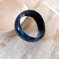 Dark blue marble acrylic cuff bracelet with smoky white swirl patterns and glossy finish - Blue