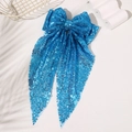 Detailed view of the sparkling blue sequins and flowing ribbons on the oversized hair bow - Blue