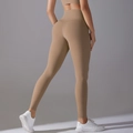 Close-up of high-waisted yoga leggings with butt-lifting cut in earth tone tech fabric - S / Cocoa