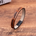 Close-up of brown PU leather bracelet with feather embossing and black magnetic clasp - Brown