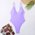 Detailed flat lay of lavender one-piece swimsuit with sunglasses and summer straw hat - Lavender