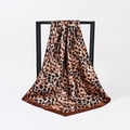 Classic leopard print satin silk headscarf in brown and black on a minimalist rack - Classic Brown Leopard (No.21)