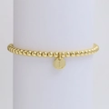 Macro detail of golden bead bracelet with letter L pendant on a white jewelry stand - Letter L (DB240603-L)