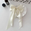 Elegante crèmekleurige satijnen haarklem met lange linten op een wit keramisch bordje - Lange Streamers / Beige