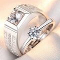 Close-up of silver couples rings featuring intricate greek key pattern and sparkling zircons - Women / Domineering Sky