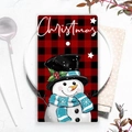 Close-up of a Christmas snowman tea towel with red plaid pattern on a white plate - XWJ02-9 (Snowman with Top Hat)