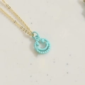 Gold chain necklace featuring a light blue enamel smiley face pendant with beaded edges - Light Blue