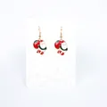Detail of Santa Claus earrings with red gift bag design in festive red and gold colors - Santa Claus with Bag