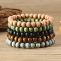 5-piece set of minimalist vintage wooden bead bracelets in earthy tones on a wood surface - Pure Wood Bead 5-piece Set