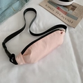 Pink canvas waist bag with adjustable black strap shown on casual background - Pink