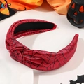 Detail of red Halloween headband with black spider web patterns and side knot design - Knotted Spider Web Red Style