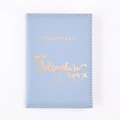 Detail of light blue PU leather passport holder with golden adventure quote engraving - Ice Blue