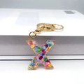 Letter X keychain with colorful heart sequins in transparent resin and golden metal ring - Letter X Lobster Clasp Keychain