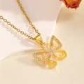 Close-up of gold bow pendant necklace with sparkling zircons on a soft textured background - Gold Bowknot Flower Diamond Necklace