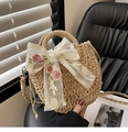 Detail der runden Strohtasche mit Spitzenschleife, Blumenstickerei und Kordelzug - Bestickter Schal-Braun