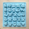 Detailed view of blue silicone mold with 25 diverse Christmas shapes for baking - Blue