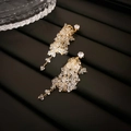 Detail view of long tassel earrings with sparkling crystals and gold plated chains - Gold Zircon Tassel (Silver Needle)
