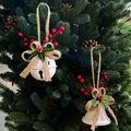 White Christmas bell ornament with burlap bow and red berries hanging on a festive tree - White Round Ball Bell
