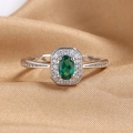 Elegant silver ring with oval emerald-green gemstone and halo diamond settings - US 6 / Green