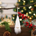 Close-up of a white knitted Christmas gnome hanging on a branch with bokeh lights background - White Style A