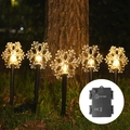 Outdoor solar snowflake garden lights with 5 LED stakes emitting warm yellow glow - Snowflake Battery Box (5-in-1 Warm White)