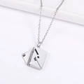 Detailed close-up of a silver envelope necklace pendant with an opening cover feature - Steel Color Plain